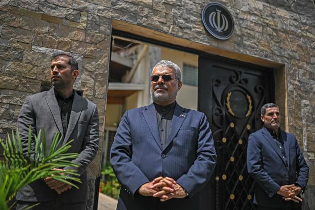 Iran's Ambassador to Venezuela, Ali Chegini (C), attens a protest in solidarity with the Islamic Republic of Iran following armed conflict with the United States and Israel outside the Iranian embassy in Caracas on March 3, 2026. (Photo by Federico PARRA / AFP)