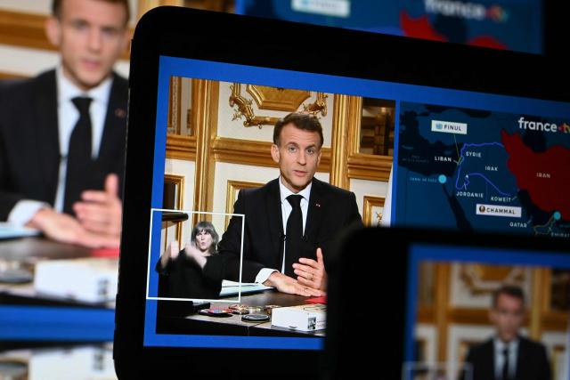 This photograph shows screens broadcasting French President Emmanuel Macron's address on the war in Iran and its repercussions in the Middle East, from the Elysee Palace in Paris on March 3, 2026. President Emmanuel Macron said on March 3, 2026 France was sending extra air defence forces and a French frigate to Cyprus following a drone attack on a British base on the Mediterranean island. (Photo by SEBASTIEN BOZON / AFP)