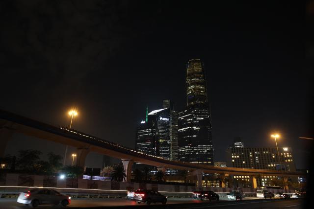 Vehciles drive past skyscrapers along the King Fahad Road, a principal transport arteries that links the city's southern and northern districts, in the Saudi capital Riyadh on March 3, 2026. The United States and Israel launched strikes against Iran on February 28, killing Iran's supreme leader and top military leaders, prompting authorities to retaliate with strikes on Israel and across the Gulf. (Photo by Fayez Nureldine / AFP)
