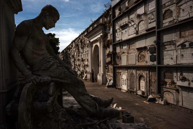 A security guard looks on near a statue at the Central Cemetery in Montevideo on March 3, 2026. (Photo by Eitan ABRAMOVICH / AFP)