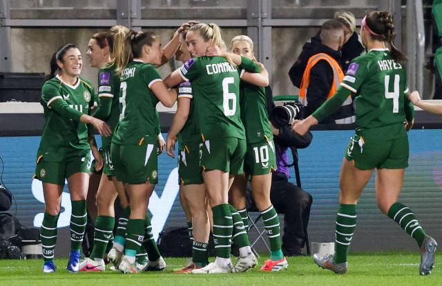 Ireland's defender #11 Katie McCabe (4L) is mobbed by teammates after scoring the opening goal during Women's World Cup 2027 Group A2 Qualifier football match between Ireland and France at Tallaght Stadium in Ireland on March 3, 2026. (Photo by Paul Faith / AFP)