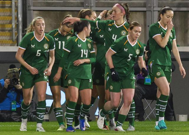Ireland's defender #11 Katie McCabe (2L) is mobbed by teammates after scoring the opening goal during Women's World Cup 2027 Group A2 Qualifier football match between Ireland and France at Tallaght Stadium in Ireland on March 3, 2026. (Photo by Paul Faith / AFP)