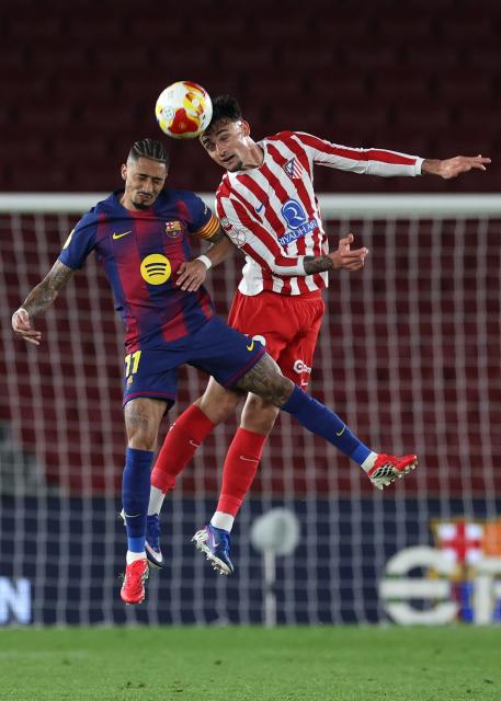Barcelona's Brazilian forward #11 Raphinha (L) and Atletico Madrid's Spanish defender #18 Marc Pubill vie for a header during the Copa del Rey (King's Cup) semi final second leg football match between FC Barcelona and Club Atletico de Madrid at Camp Nou Stadium in Barcelona on March 3, 2026. (Photo by Josep LAGO / AFP)