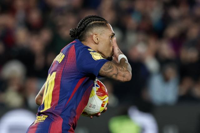 Barcelona's Brazilian forward #11 Raphinha celebrates scoring his team's second goal during the Copa del Rey (King's Cup) semi final second leg football match between FC Barcelona and Club Atletico de Madrid at Camp Nou Stadium in Barcelona on March 3, 2026. (Photo by Lluis GENE / AFP)
