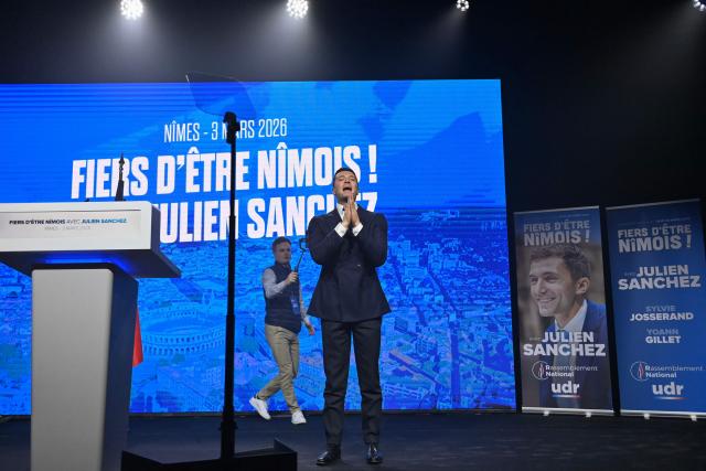 President of French far-right party Rassemblement National (RN) Jordan Bardella acknowledges the audience upon arrival at a campaign meeting to support National Rally (RN)'s Nimes mayoral candidate Julien Sanchez, ahead of France's upcoming municipal elections in Nimes, southern France on March 3, 2026. French voters head to the polls for municipal elections on March 15 and 22, 2026. (Photo by Sylvain THOMAS / AFP)