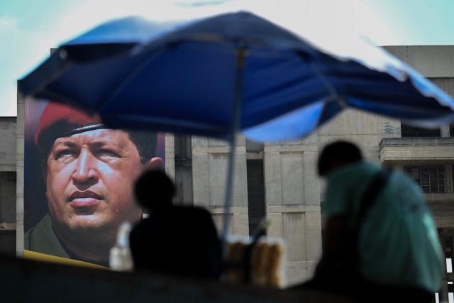 A banner of former Venezuelan president Hugo Chavez is seen in Caracas on March 3, 2026. (Photo by Juan BARRETO / AFP)