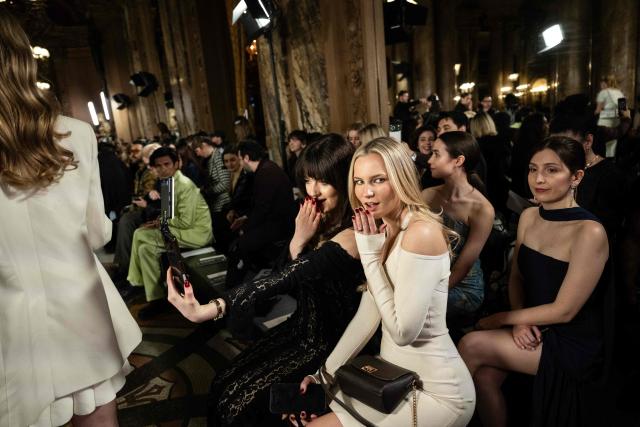 Guests react as they wait for a Women's Ready to Wear Fall/Winter 2026-2027 collection fashion show as part of the Paris Women Fashion Week, at the Palais Garnier, in Paris, on March 3, 2026. (Photo by Blanca CRUZ / AFP)