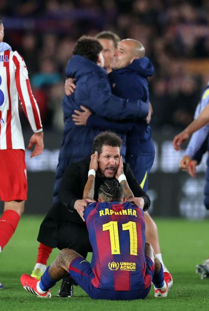 Atletico Madrid's Argentine coach Diego Simeone conforts Barcelona's Brazilian forward #11 Raphinha at the end of the Copa del Rey (King's Cup) semi final second leg football match between FC Barcelona and Club Atletico de Madrid at Camp Nou Stadium in Barcelona on March 3, 2026. (Photo by Josep LAGO / AFP)