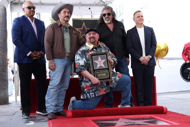 (L-R) Sports analyst Jonathan Coachman, comedian Alfred Robles, comedian Gabriel "Fluffy" Iglesias, actor Martin Moreno and talent manager Joe Meloche pose on Iglesias' newly unveilled Star on the Walk of Fame in the Hollywood neighborhood of Los Angeles, California on March 3, 2026. (Photo by VALERIE MACON / AFP)