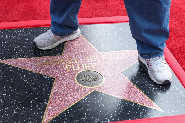 US comedian and actor Gabriel "Fluffy" Iglesias (detail shoes) poses on his newly unveilled Walk of Fame Star in the Hollywood neighborhood of Los Angeles, California on March 3, 2026. (Photo by VALERIE MACON / AFP)