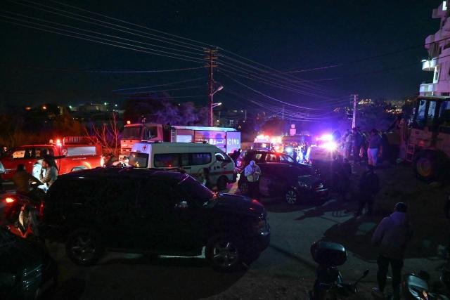 Rescuers are seen at the site of an Israeli airstrike that targeted a building in the town of Aramoun, south of Beirut on March 4, 2026. A loud explosion was heard by an AFP journalist in the Lebanese capital Beirut shortly after midnight on March 4, as Israel and Hezbollah traded strikes and rocket fire. Tehran-backed Hezbollah reprised its rocket and drone attacks on Israel on March 2 after a long hiatus in retaliation for the killing of Iranian supreme leader Ayatollah Ali Khamenei in a wave of joint US-Israeli strikes. (Photo by FADEL itani / AFP)