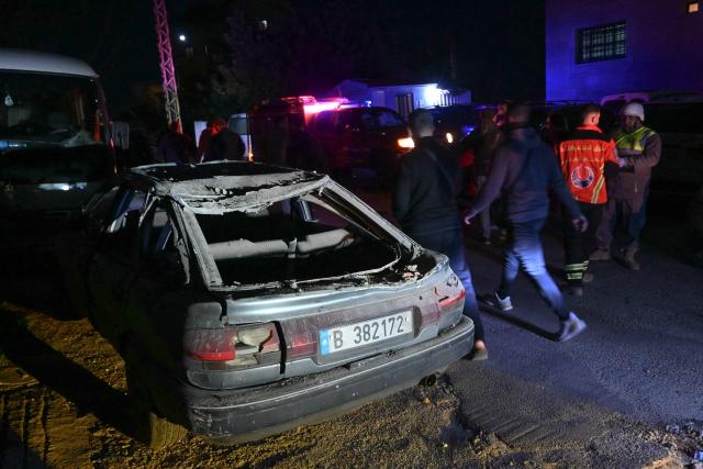 Rescuers work near a damaged car at the site of an Israeli airstrike that targeted a building in the town of Aramoun, south of Beirut on March 4, 2026. A loud explosion was heard by an AFP journalist in the Lebanese capital Beirut shortly after midnight on March 4, as Israel and Hezbollah traded strikes and rocket fire. Tehran-backed Hezbollah reprised its rocket and drone attacks on Israel on March 2 after a long hiatus in retaliation for the killing of Iranian supreme leader Ayatollah Ali Khamenei in a wave of joint US-Israeli strikes. (Photo by FADEL itani / AFP)