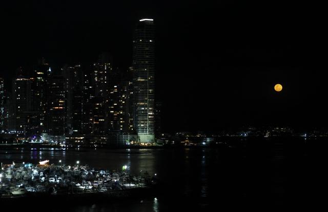 EDITORS NOTE: Graphic content / The moon rises in its waxing gibbous phase over the artificial islands of Ocean Reef Islands in Panama City on March 3, 2026. (Photo by Martin BERNETTI / AFP)
