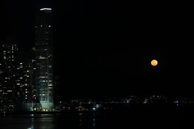 EDITORS NOTE: Graphic content / The moon rises in its waxing gibbous phase over the artificial islands of Ocean Reef Islands in Panama City on March 3, 2026. (Photo by Martin BERNETTI / AFP)