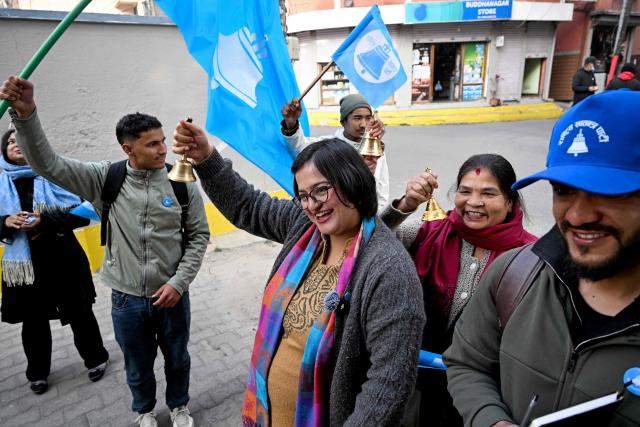 This photograph taken on February 13, 2026 shows Rastriya Swatantra Party (RSP) election candidate Ranju Darshana (C) taking part in a door-to-door campaign with her party workers ahead of Nepal's general election in Kathmandu. Nepali women risked their lives in the September 2025 deadly anti-corruption protests that toppled the government. But when the country votes on March 5, they will be largely absent from the ballot as candidates. Darshana, while heavily pregnant is among the few women running  that make up only 10 percent of more than 3,400 candidates in the direct vote. (Photo by Prakash MATHEMA / AFP) / TO GO WITH 'Nepal-Politics-Election-Women' FOCUS