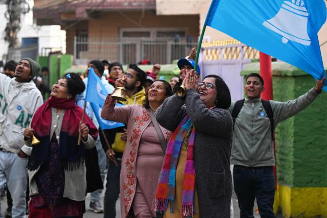 This photograph taken on February 13, 2026 shows Rastriya Swatantra Party (RSP) election candidate Ranju Darshana (2R) taking part in a door-to-door campaign with her party workers ahead of Nepal's general election in Kathmandu. Nepali women risked their lives in the September 2025 deadly anti-corruption protests that toppled the government. But when the country votes on March 5, they will be largely absent from the ballot as candidates. Darshana, while heavily pregnant is among the few women running  that make up only 10 percent of more than 3,400 candidates in the direct vote. (Photo by Prakash MATHEMA / AFP) / TO GO WITH 'Nepal-Politics-Election-Women' FOCUS