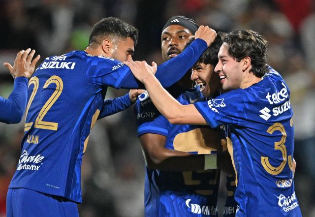 Pumas' Paraguayan forward #31 Robert Morales (R) celebrates with teammates after scoring his team's second goal during the Liga MX Clausura match between Pumas and Toluca at Olimpico Universitario Stadium in Mexico City on March 3, 2026. (Photo by Carl DE SOUZA / AFP)