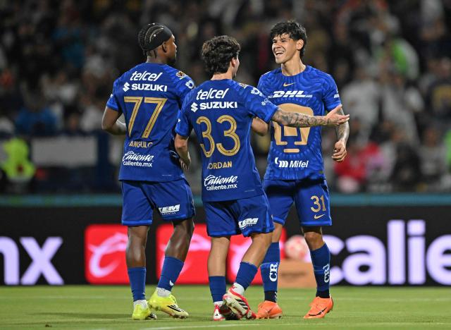 Pumas' Paraguayan forward #31 Robert Morales (R) celebrates with teammates after scoring his team's second goal during the Liga MX Clausura match between Pumas and Toluca at Olimpico Universitario Stadium in Mexico City on March 3, 2026. (Photo by Carl DE SOUZA / AFP)