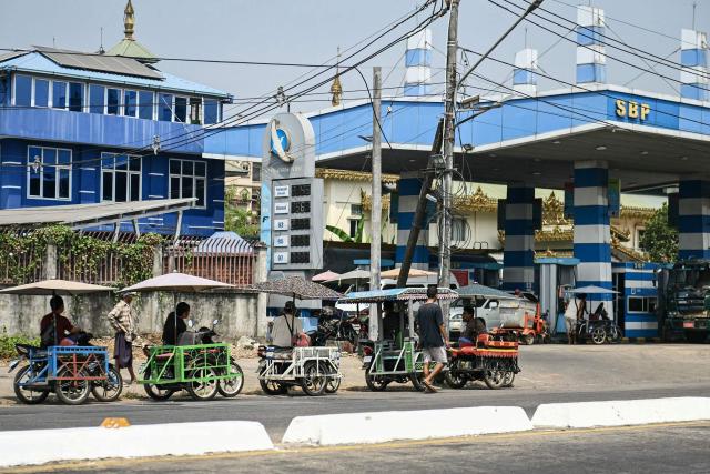 Motorists queue at a petrol station in Yangon on March 4, 2026. As strikes on Iran moved into a fifth day, observers warned March 4 that the continued choking of crude supplies from the Middle East would continue to push energy prices higher. (Photo by Sai Aung MAIN / AFP)