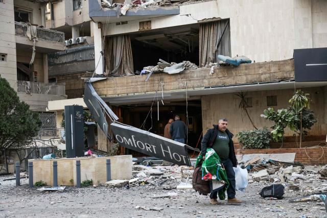 TOPSHOT - A man leaves a hotel after it was hit by an Israeli airstrike in Hazmieh, east of Beirut, on March 4, 2026. Israel launched fresh strikes on Iran and Lebanon, where state media reported a residential building was hit on March 4, as Iran's Guards said they had sealed off one of the world's most vital shipping routes for energy. (Photo by IBRAHIM AMRO / AFP)