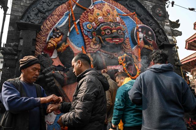 Men visit a shrine at Durbar Square in Kathmandu on March 4, 2026, a day before Nepal's general election. Nepal set up polling centres on March 4 for one of its most hotly contested elections since the end of civil war in 2006, six months after deadly anti-corruption protests toppled the government. (Photo by TAUSEEF MUSTAFA / AFP)