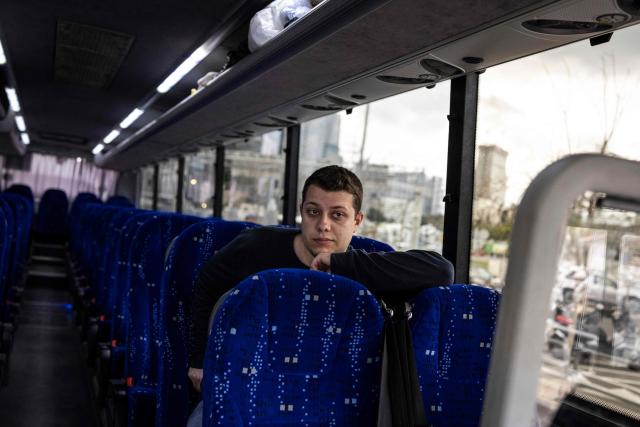 A tourist waits aboard a bus that will evacuate him, along with others, to the Taba border crossing with Egypt in Tel Aviv on March 4, 2026. Israel launched fresh strikes on Iran and Lebanon, where state media reported a residential building was hit on March 4, as Iran's Guards said they had sealed off one of the world's most vital shipping routes for energy. (Photo by John WESSELS / AFP)