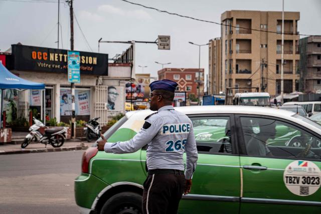 A policeman directs traffic in Brazzaville on March 3, 2026, ahead of the country's March 15 presidential election. Congo-Brazzaville, a former French colony which gained independence in 1960, is rich in oil but nearly half of its six million people live below the poverty line. (Photo by Glody MURHABAZI / AFP)