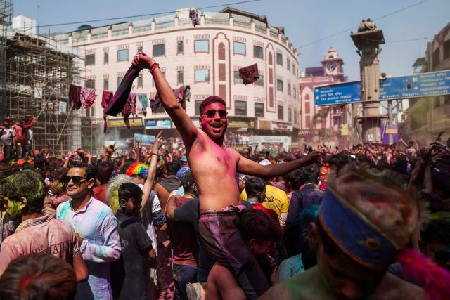 Revellers dance during celebrations on the occasion of Holi, the Hindu spring festival of colours in Varanasi on March 4, 2026. (Photo by Niharika KULKARNI / AFP)