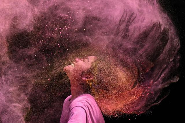 A girl smeared with coloured powder celebrates the Hindu spring festival of Holi in Chennai on March 4, 2026. (Photo by R. Satish BABU / AFP)
