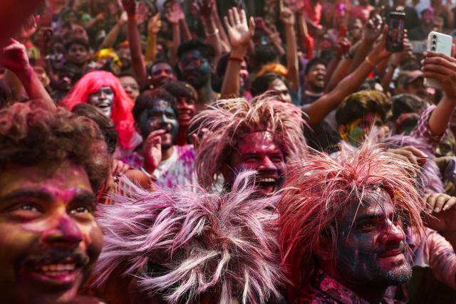 Revellers dance during celebrations on the occasion of Holi, the Hindu spring festival of colours at Assi Ghat in Varanasi on March 4, 2026. (Photo by Niharika KULKARNI / AFP)