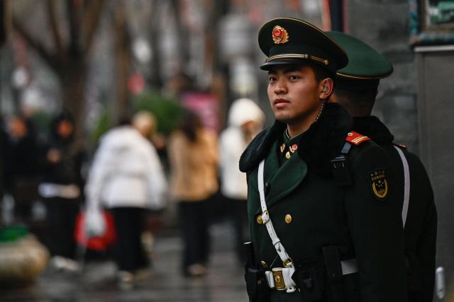 Chinese paramilitary policemen stand guard in a street surrounding the Great Hall of the People where the opening of the Chinese People's Political Consultative Conference (CPPCC) takes place, in Beijing on March 4, 2026. (Photo by Pedro PARDO / AFP)