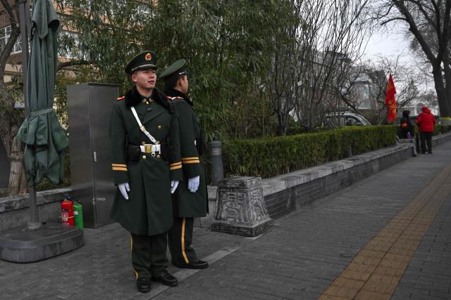 Chinese paramilitary policemen stand guard in a street surrounding the Great Hall of the People where the opening of the Chinese People's Political Consultative Conference (CPPCC) takes place, in Beijing on March 4, 2026. (Photo by Pedro PARDO / AFP)