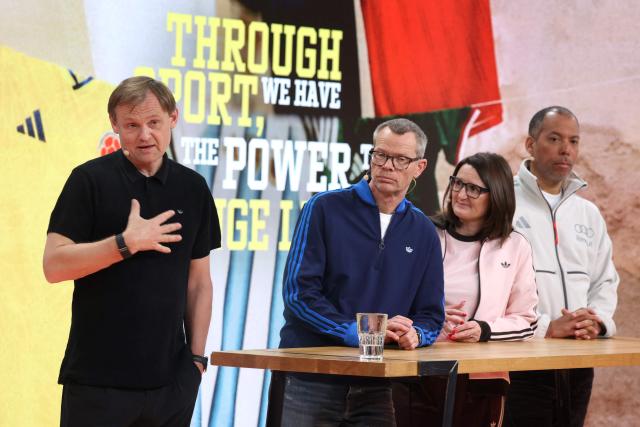 (L-R) Bjoern Gulden, Chief Executive Officer of German sportswear giant Adidas, Harm Ohlmeyer, Chief Financial Officer, Michelle Robertson, Global Human Resources, and Mathieu Sidokpohou, Sales Director, attend the company's annual press conference in Herzogenaurach, southern Germany, on March 4, 2026. Adidas shares slumped after the company gave a disappointing 2026 profit forecast and warned of a 400-million-euro ($465-million) hit from US tariffs and exchange rate effects. The maker of Gazelle and Samba trainers said it expects operating profit to rise to 2.3 billion euros for 2026, as it unveiled its annual results. The group's shares fell about eight percent on the Frankfurt Stock Exchange after the announcement, and were trading around 137 euros each. (Photo by Karl-Josef Hildenbrand / AFP)