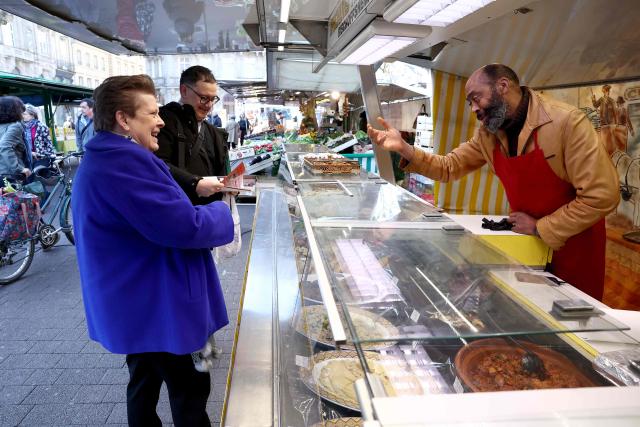 Socialist Party (PS)'s Strasbourg mayoral candidate Catherine Trautmann speaks with vendors during her visit to a local market ahead of France's upcoming municipal elections in Strasbourg, eastern France on March 4, 2026. (Photo by FREDERICK FLORIN / AFP)