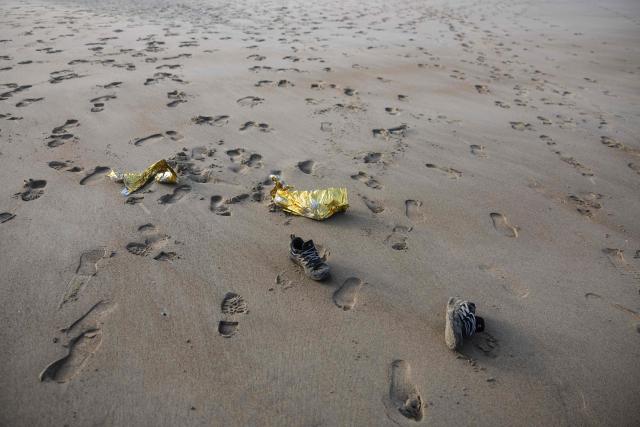 This photograph shows abandoned shoes and a survival blanket on the beach after migrants boarded a smugglers' boat in an attempt to cross the English Channel off the beach of Gravelines, northern France, on March 4, 2026. (Photo by Sameer Al-DOUMY / AFP)