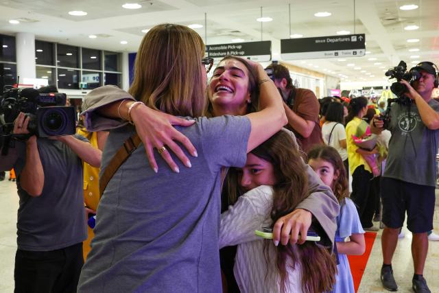 Passengers arrive from a Dubai flight at Sydney Kingsford Smith International Airport on March 4, 2026. Thousands of flights have been delayed or cancelled in the biggest disruption to global air transport since the Covid pandemic as airlines suspend services to the Middle East following the US and Israeli attacks on Iran. (Photo by Izhar KHAN / AFP)