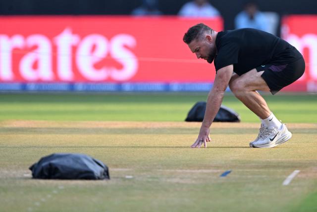 England’s head coach Brendon McCullum checks the pitch during a training session on the eve of their 2026 ICC Men's T20 Cricket World Cup semi-final match against India at the Wankhede Stadium in Mumbai on March 4, 2026. (Photo by Punit PARANJPE / AFP)