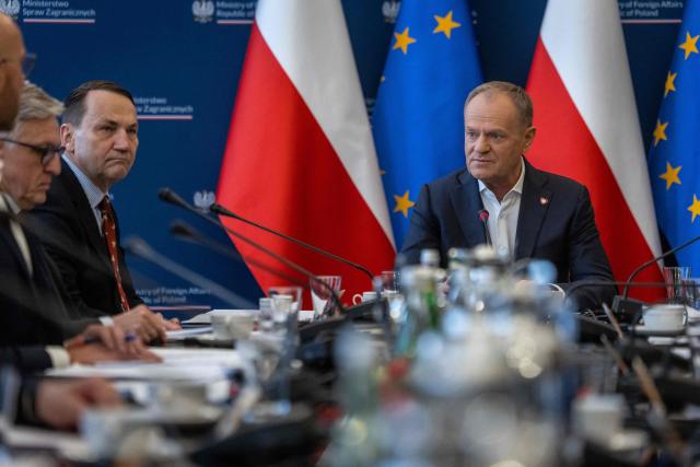 Poland's Prime Minister Donald Tusk (R) and Deputy Prime Minister and Minister of foreign Afairs Radoslaw Sikorski (2nd R) take part in a meeting of a Coordinating Committee on the Situation in the Middle East at Polish Foreign Afairs Ministry building in Warsaw on March 4, 2026. (Photo by Wojtek RADWANSKI / AFP)