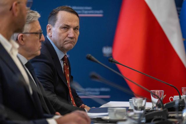 Poland's Prime Minister Donald Tusk (R) and Deputy Prime Minister and Minister of foreign Afairs Radoslaw Sikorski (2nd R) take part in a meeting of a Coordinating Committee on the Situation in the Middle East at Polish Foreign Afairs Ministry building in Warsaw on March 4, 2026. (Photo by Wojtek RADWANSKI / AFP)