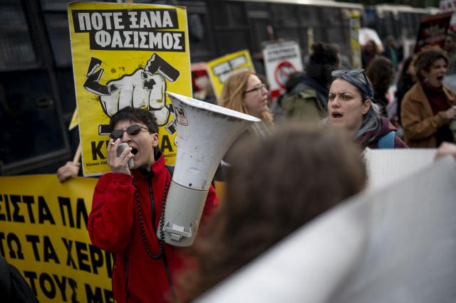 A protester shouts slogans in a megaphone during an antifascist demonstration outside of the Greek court of appeal during the trial of far-right party Golden Dawn. A Greek appeals court on March 4, 2026 convicted senior officials in the neo-Nazi Golden Dawn party for "belonging to and running a criminal organisation" in a landmark trial. (Photo by Aggelos NAKKAS / AFP)