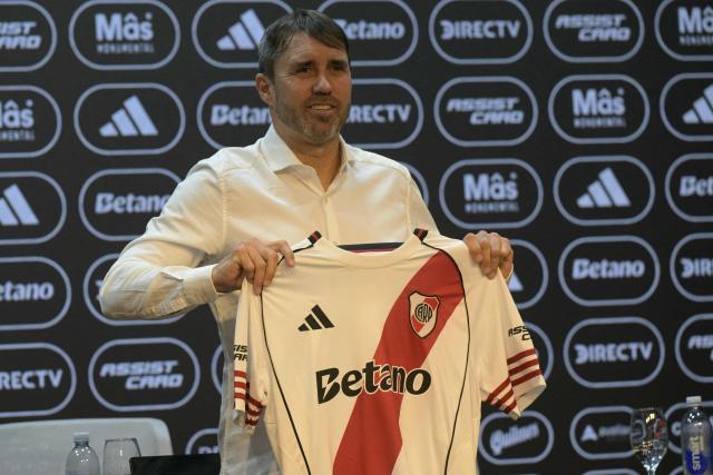 Eduardo Coudet, Argentina's football side Rive Plate new head coach, poses for pictures holding a shirt during his presentation at the Mas Monumental stadium in Buenos Aires on March 4, 2026. (Photo by JUAN MABROMATA / AFP)