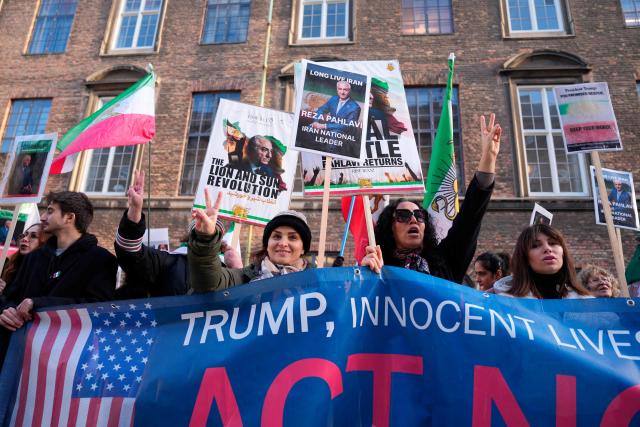 Protesters hold placards featuring Reza Pahlavi, Iran's former crown prince and now key opposition figure, during a demonstration for a free Iran in the Parliament Courtyard at Christiansborg in Copenhagen on March 4, 2026. (Photo by Liselotte Sabroe / Ritzau Scanpix / AFP) / Denmark OUT