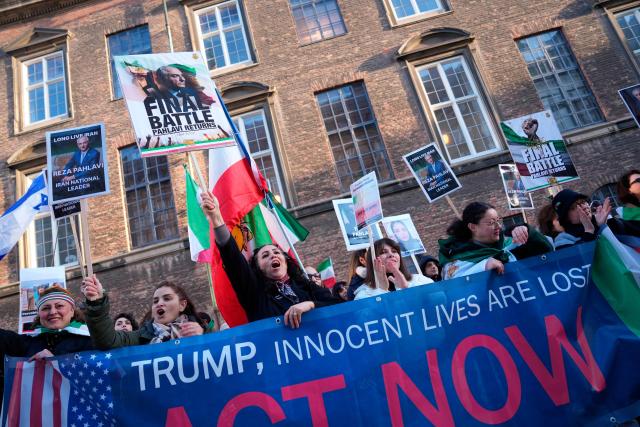 Protesters hold placards featuring Reza Pahlavi, Iran's former crown prince and now key opposition figure, during a demonstration for a free Iran in the Parliament Courtyard at Christiansborg in Copenhagen on March 4, 2026. (Photo by Liselotte Sabroe / Ritzau Scanpix / AFP) / Denmark OUT