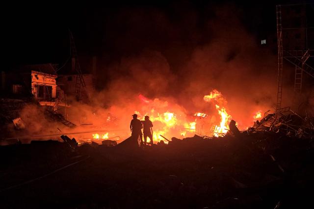 Civil defence forces attempt to extinguish a blaze that erupted after Israeli bombardment on a solar farm and electricity generation facility in Lebanon's southern coastal city of Tyre on March 4, 2026. Israeli forces on March 4 advanced into a number of towns and villages in south Lebanon, a source from the UN peacekeeping force in the country, UNIFIL, told AFP. (Photo by KAWANT HAJU / AFP)