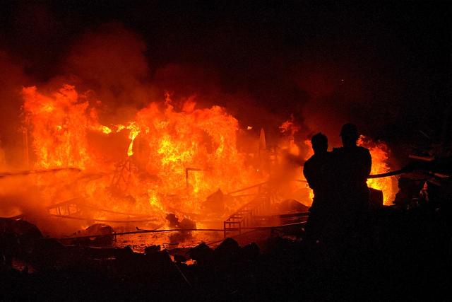 Civil defence forces attempt to extinguish a blaze that erupted after Israeli bombardment on a solar farm and electricity generation facility in Lebanon's southern coastal city of Tyre on March 4, 2026. Israeli forces on March 4 advanced into a number of towns and villages in south Lebanon, a source from the UN peacekeeping force in the country, UNIFIL, told AFP. (Photo by KAWANT HAJU / AFP)