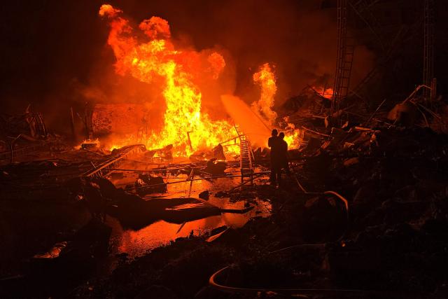 TOPSHOT - Civil defence forces attempt to extinguish a blaze that erupted after Israeli bombardment on a solar farm and electricity generation facility in Lebanon's southern coastal city of Tyre on March 4, 2026. Israeli forces on March 4 advanced into a number of towns and villages in south Lebanon, a source from the UN peacekeeping force in the country, UNIFIL, told AFP. (Photo by Kawnat HAJU / AFP)