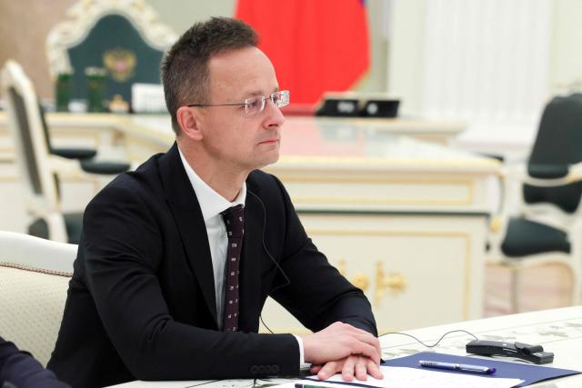 In this pool photograph distributed by the Russian state agency Sputnik Hungarian Foreign Minister Peter Szijjarto meets with Russia's pesident in Moscow on March 4, 2026. (Photo by Mikhail METZEL / POOL / AFP)