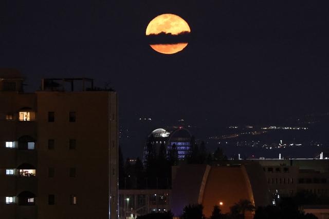 The waning gibbous moon rises over Tel Aviv after sunset on March 4, 2026. (Photo by Jack GUEZ / AFP)