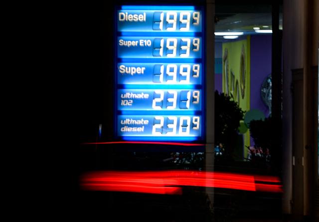 A car passes an illuminated display showing the prices at a gas station in Berlin on March 4, 2026. Oil prices are expected to rise after traffic through the Strait of Hormuz has almost entirely halted following Iran's threat to attack ships that would try to sail through. (Photo by Tobias SCHWARZ / AFP)