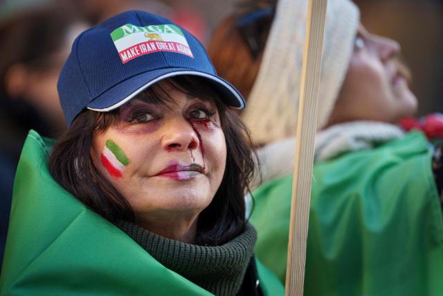 A protester wears a "Make Iran Great Again" (MIGA) hat during a demonstration for a free Iran in the Parliament Courtyard at Christiansborg in Copenhagen on March 4, 2026. (Photo by Liselotte Sabroe / Ritzau Scanpix / AFP) / Denmark OUT